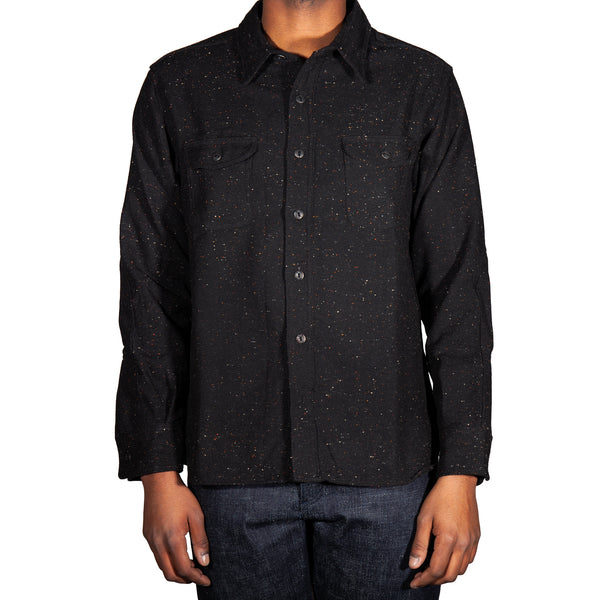 Black textured shirt worn by a person on a white background