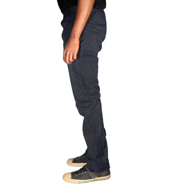 Dark gray pants worn by a person on a white background