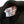 Close-up of a label on a dark knitted garment with 'Left Field Sportswear New York' text.