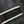 Close-up of black denim fabric with white stitching detail