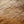 Close-up of a brown knit fabric texture with a fine ribbed pattern and soft gradient shading.
