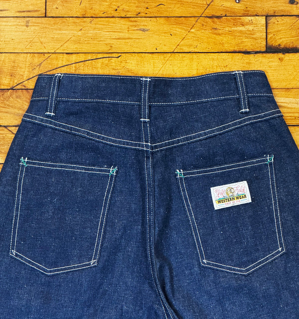 Blue jeans with a brand label on a wooden floor