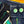 Two green pins on a denim fabric background